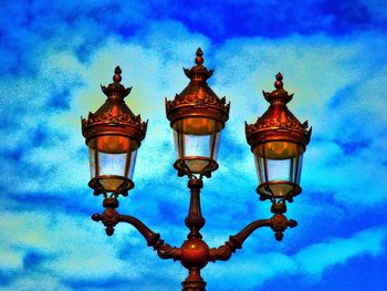 Low angle view of street light against cloudy sky