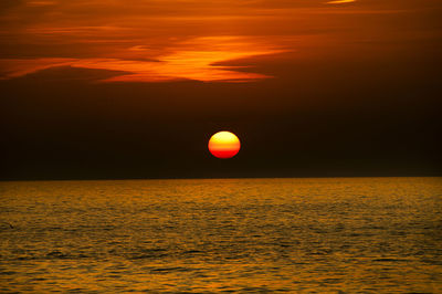 Scenic view of sea against orange sky