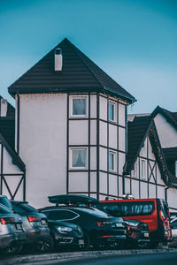 Cars on street against clear blue sky