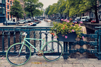 Bicycle parked by canal in city