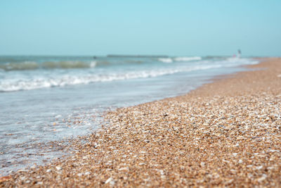 Surface level of beach against clear sky