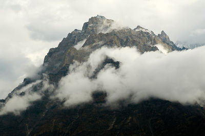 Low angle view of snowcapped mountains against sky