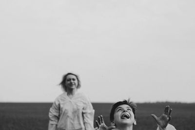 Smiling young woman against clear sky