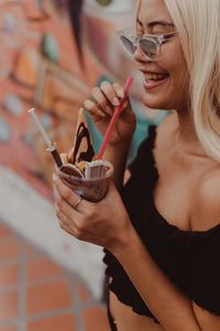 Portrait of woman holding ice cream