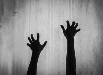 Silhouette man hand against sky