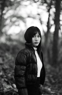 Portrait of young woman standing outdoors