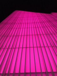 Low angle view of multi colored umbrella against black background