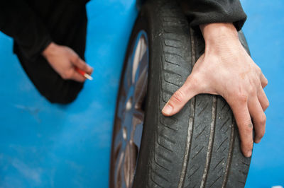 Cropped image of mechanic repairing tire