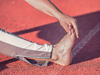 Female athlete doing preventive exercises against cramps and tendon and muscle injuries.