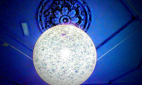 Low angle view of illuminated electric light