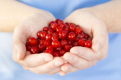Close-up of cropped hand holding strawberry
