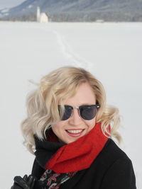 Mid adult woman standing on snow covered mountain