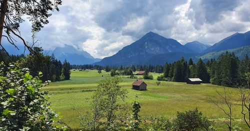 Scenic view of field and mountains against sky