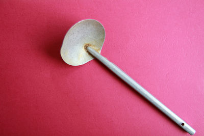 High angle view of metal in container against pink background