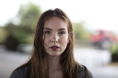 Portrait of confident young woman standing outdoors 