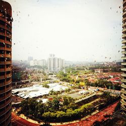 View of cityscape against sky during rainy season