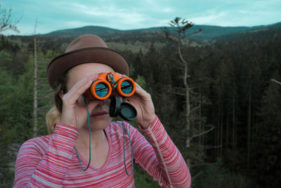 Close-up of woman looking through binoculars