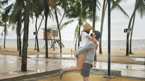 Full length of woman on palm trees at beach