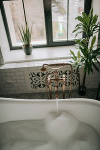 Luxury interior of big bathroom at modern african style with oval bathtub in natural lighting