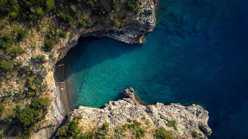 High angle view of rocks in sea