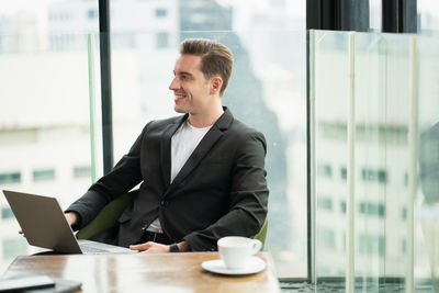 Man sitting on table at window