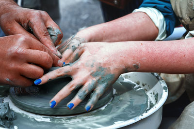 Close-up of hands working in water