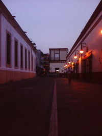 People walking on footpath at night