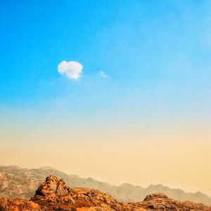Scenic view of mountains against blue sky