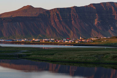 Scenic view of lake and mountains against sky