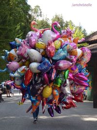 Close-up of multi colored toys on street in city