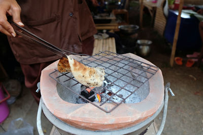 Man eating food on barbecue grill