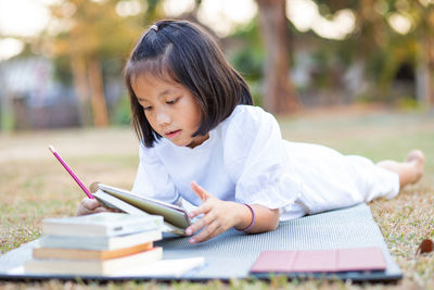 Girl sitting on book