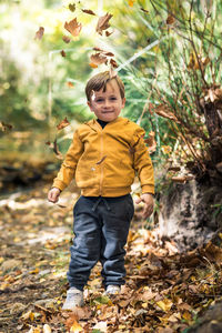 Portrait of boy standing on field