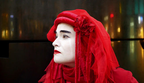 Close-up portrait of woman wearing red hat