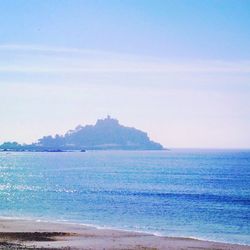 Scenic view of beach against blue sky