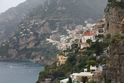 Scenic view of sea by mountains