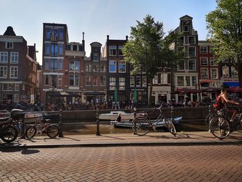 People on street against buildings in city