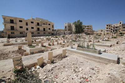 Graveyard against buildings in city