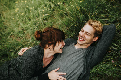 Young couple kissing on grass