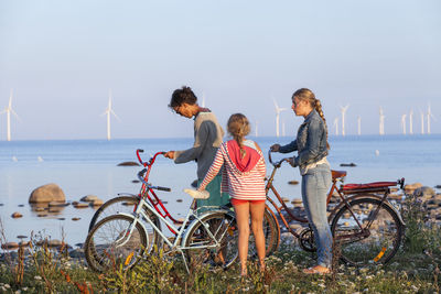 Mother with daughters cycling, oland, sweden