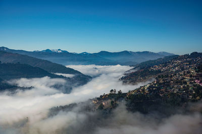 Scenery of a city in the mountain covered with clouds