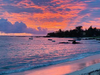 Scenic view of sea against orange sky