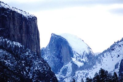 Low angle view of mountain against blue sky