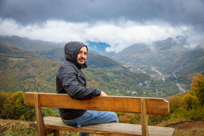 Portrait of man sitting on mountain
