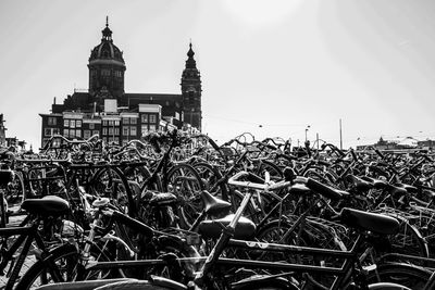 Bicycle by building against clear sky