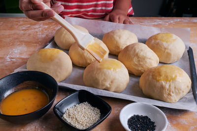 Close-up of person preparing food on table