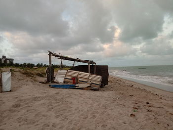 Lifeguard hut on beach against sky