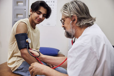 Doctor measuring patient's blood pressure