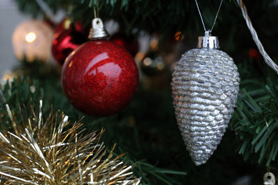 Close-up of christmas decorations hanging on tree