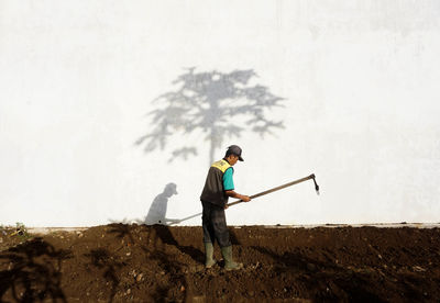 Man standing on field against sky